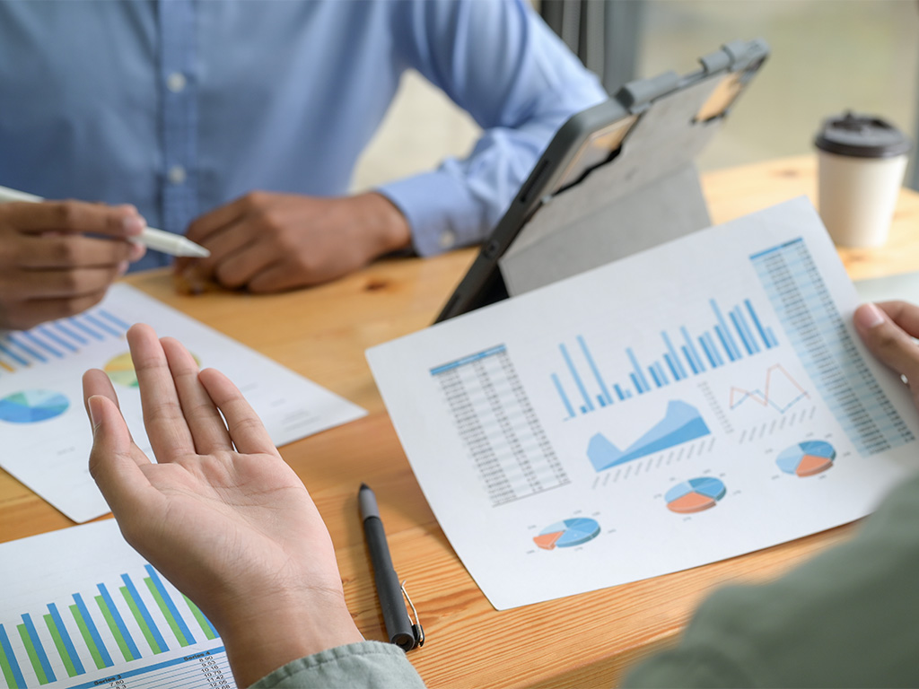 Person showing business performance using graphs